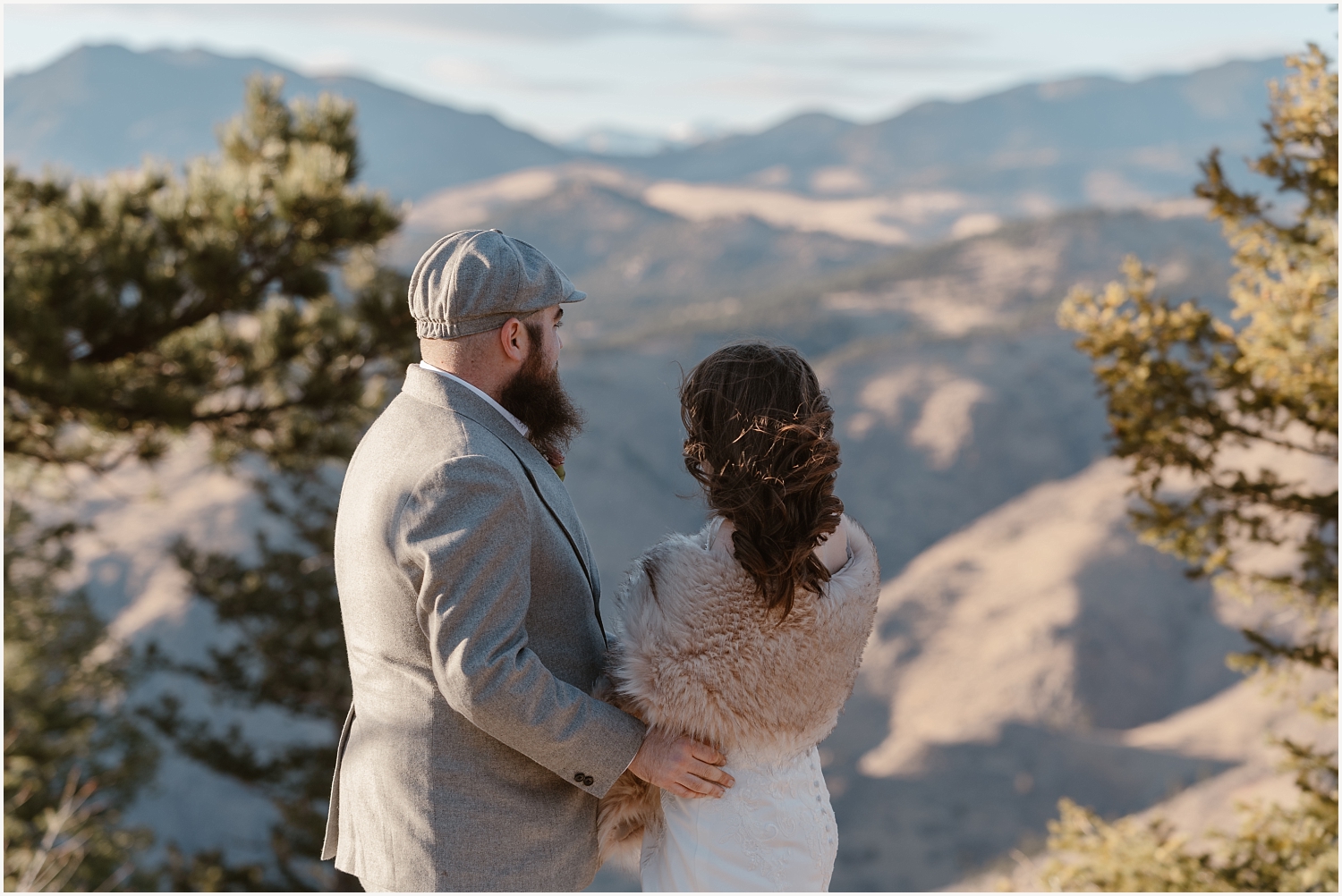Denver Elopement Guide. Couple looks out onto Denver Mountain during elopement