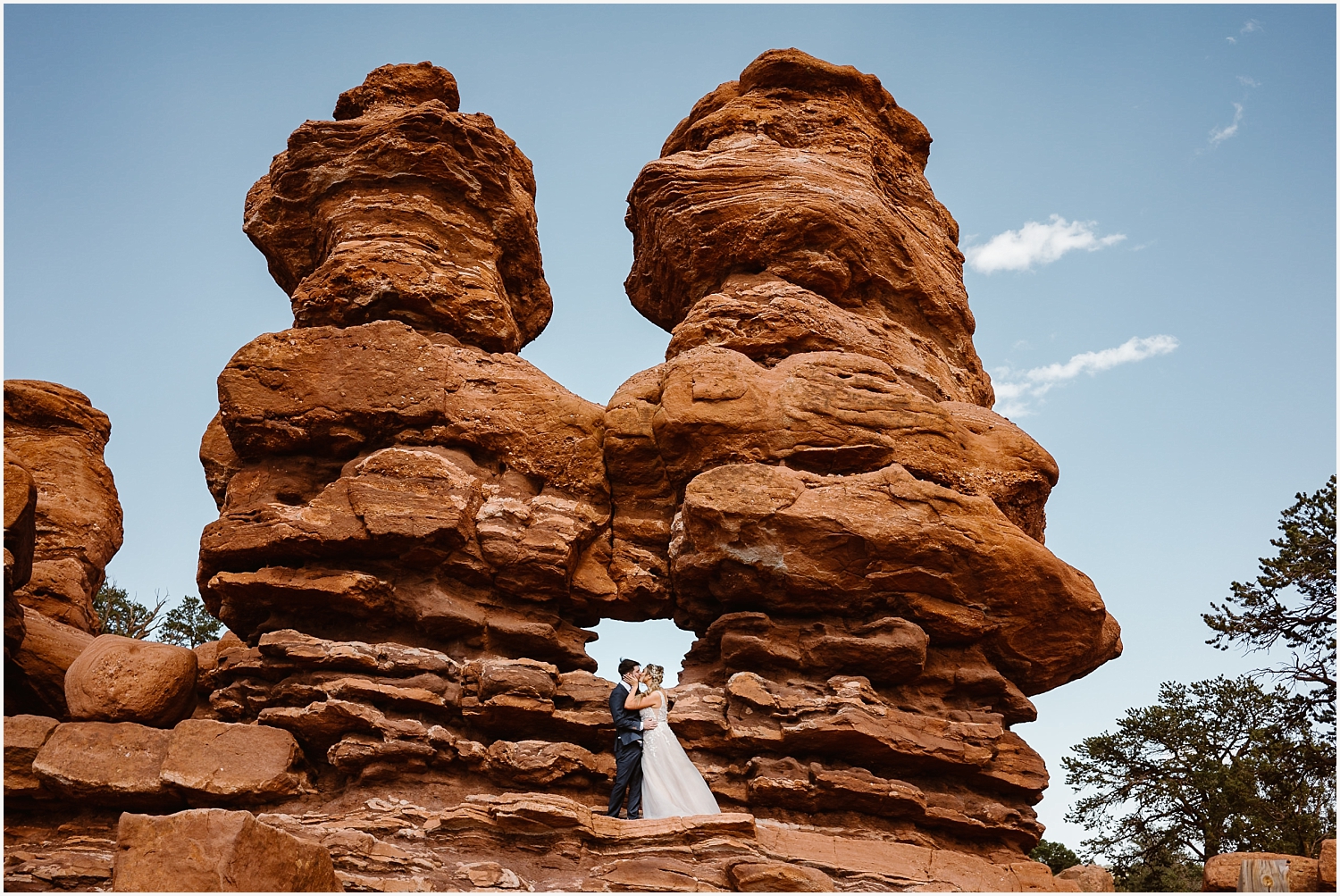 Couple stands by Siamese Twins for their Garden of the Gods elopements in the Summer