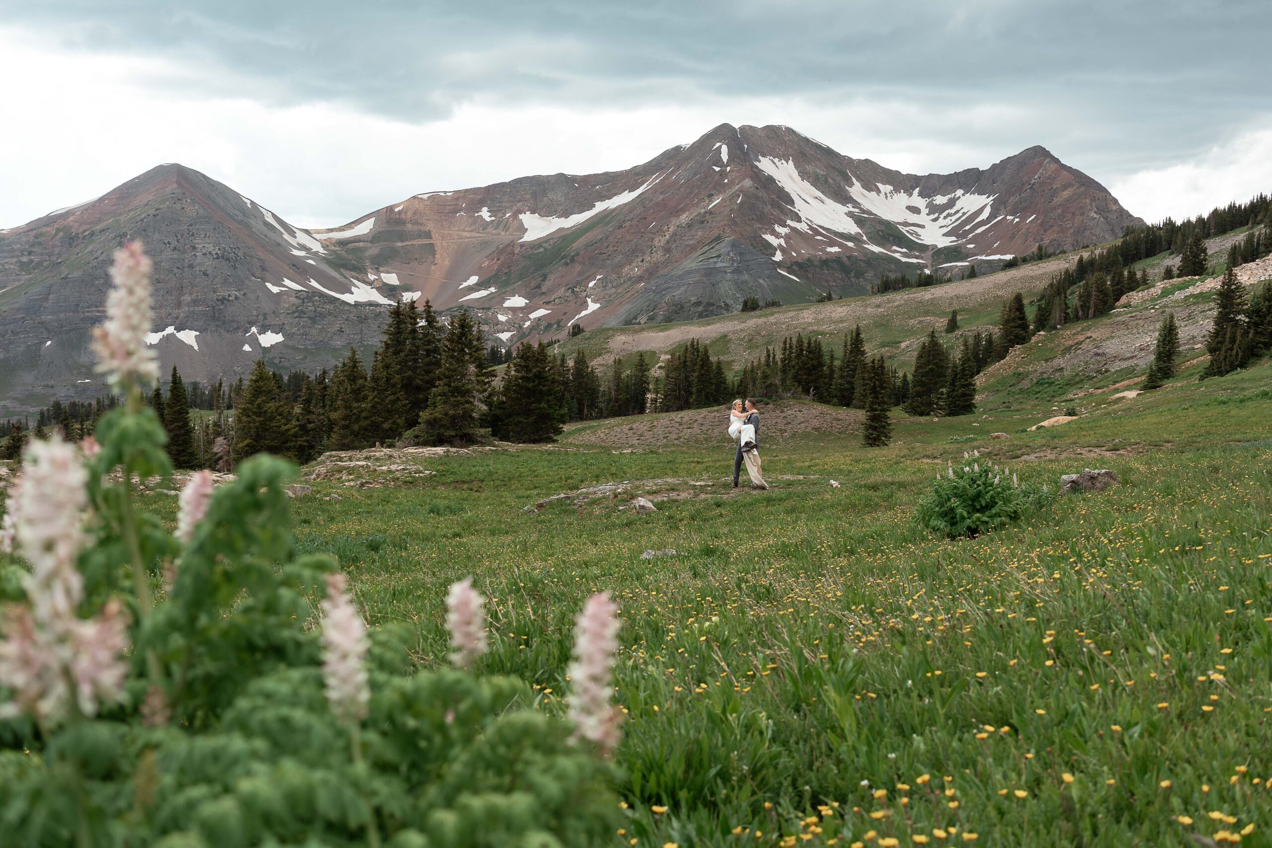 Bride and groom surrounded by wildflowers in Crested Butte elopement.