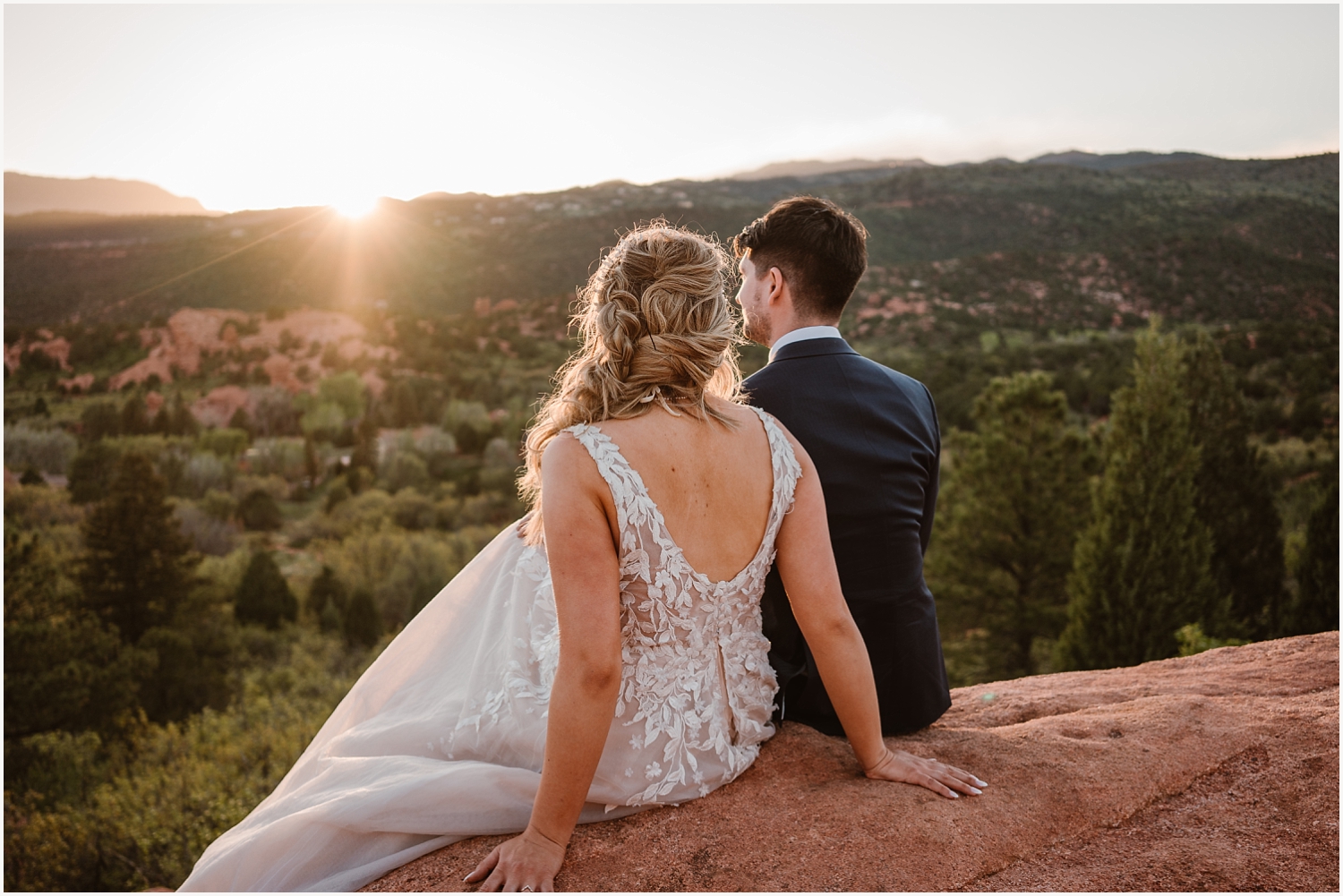Bride and groom watching the sunset on their elopement day