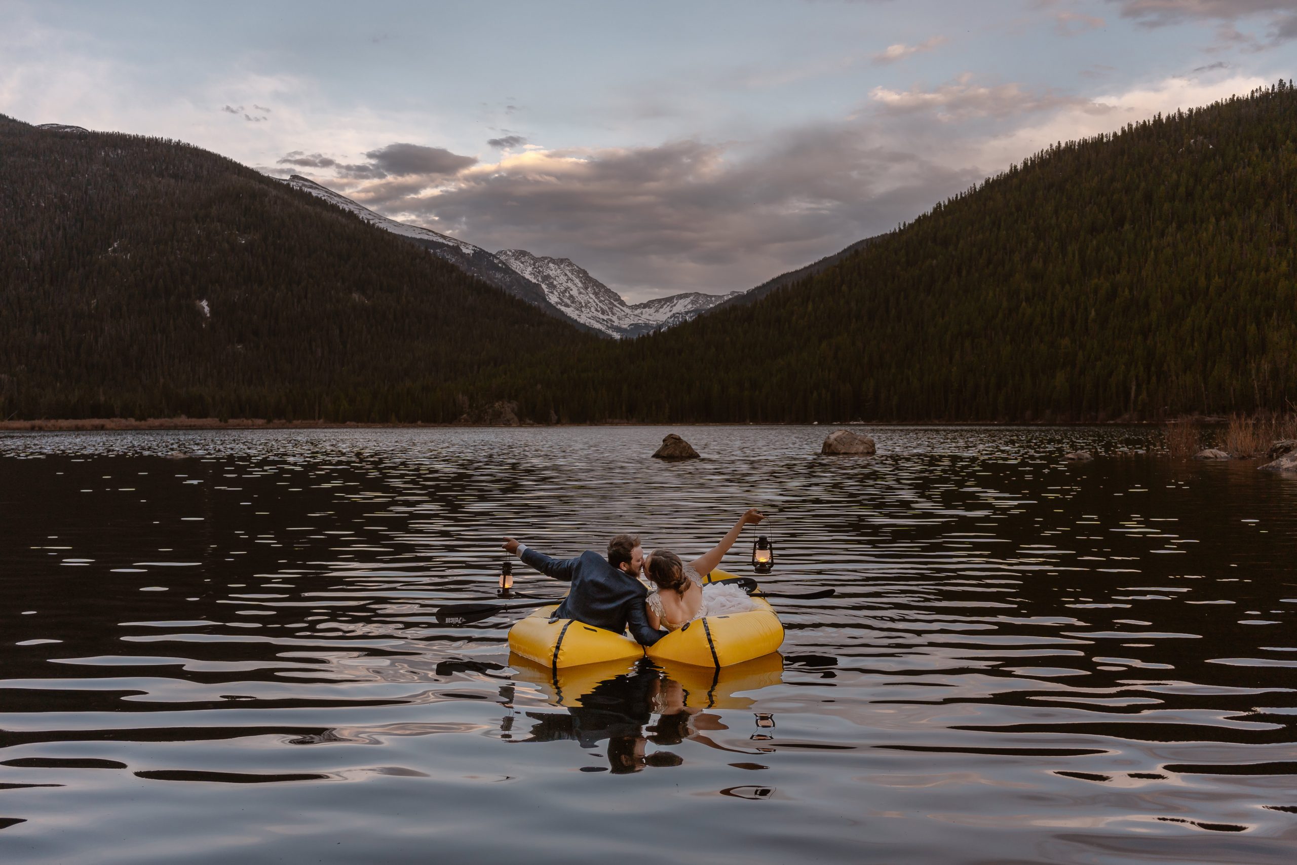 Elopement couple kayaking during sunset on an alpine lake