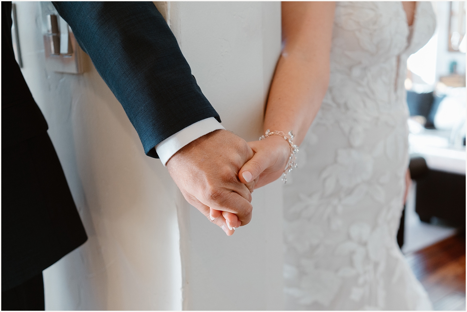 Couple holds hands for their first touch
