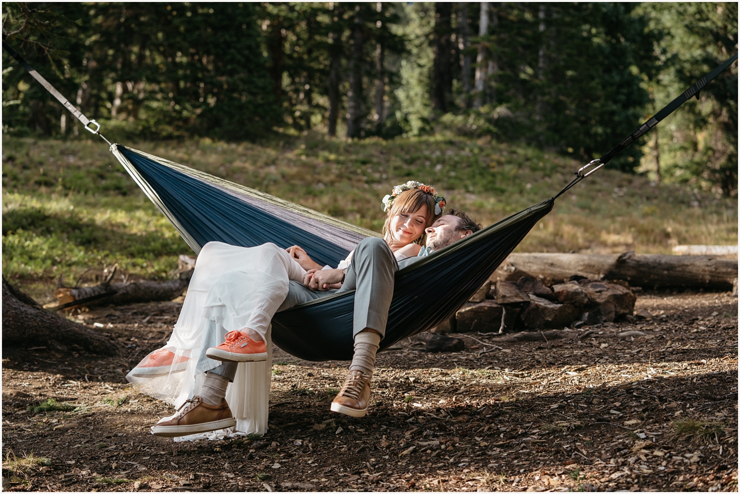 Bride and groom swing in hammock during their mountain elopement