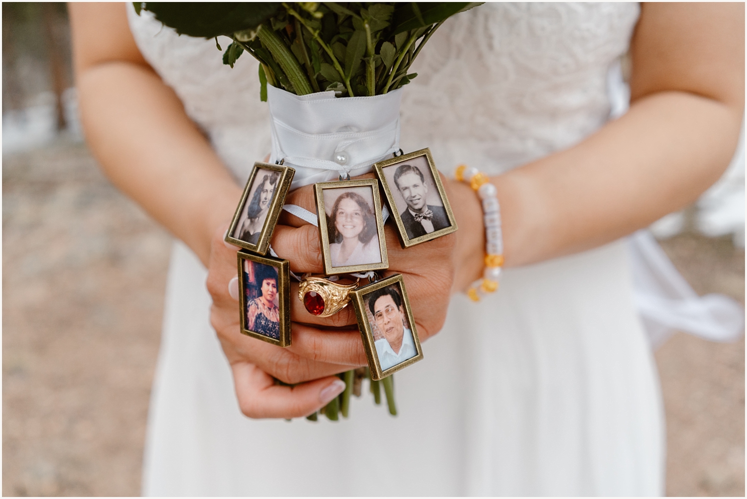 Bride has pictures of family on her bouquet. 