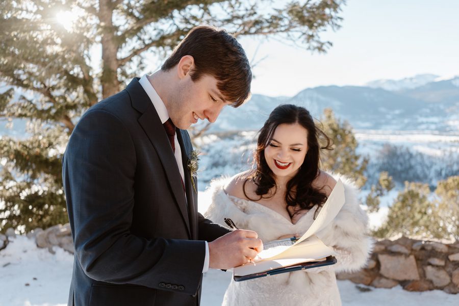 A bride and groom sign their marriage license after their elopement ceremony in Breckenridge. 