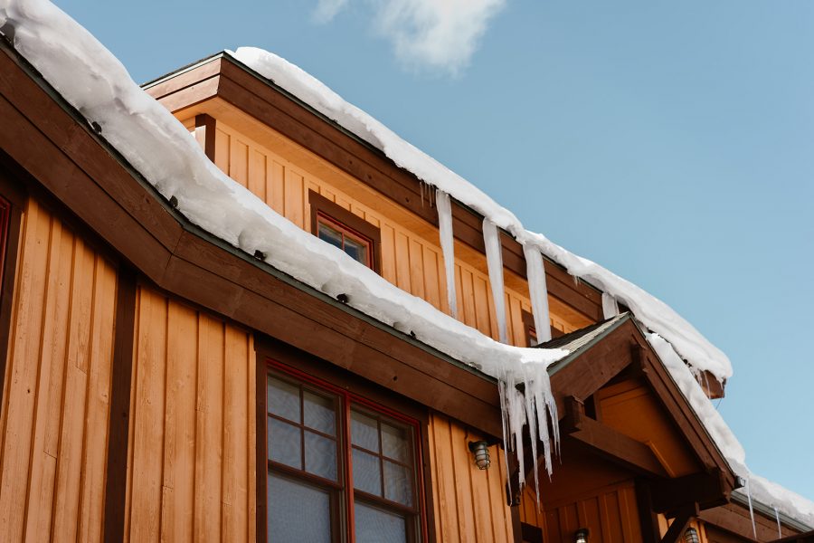 A snowy, icy Airbnb in Breckenridge is shown in this image of a Breckenridge winter elopement. 