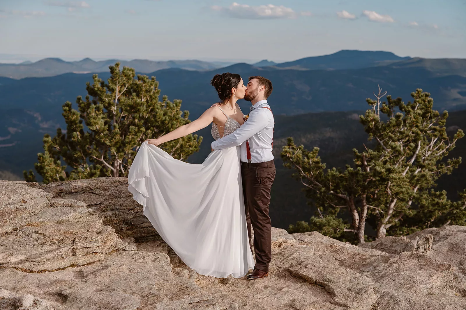 A couple embrace on the top of a mountain in their Fall Denver elopement.