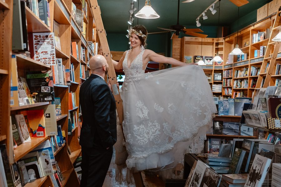 The bride and grooms day didn't unfold as they planned, but that didn't stop them from exploring an old bookstore–the perfect addition to their winter Telluride elopement.