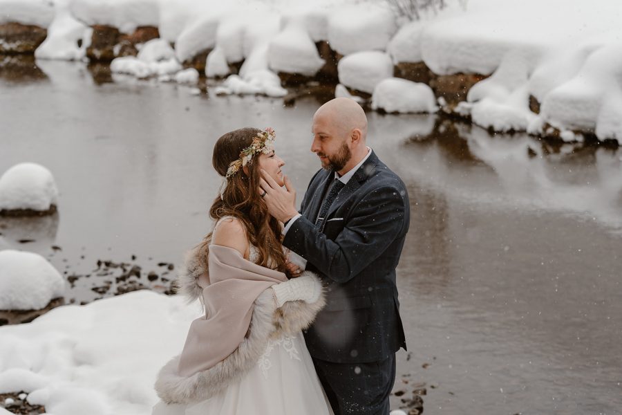 A bride and groom hold each other close as they explore the fresh snow during their winter Telluride elopement.