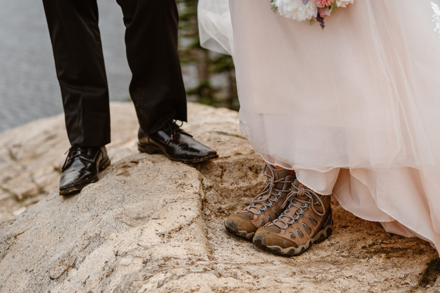A couple shows off their hiking boots during their Colorado hiking elopement. 