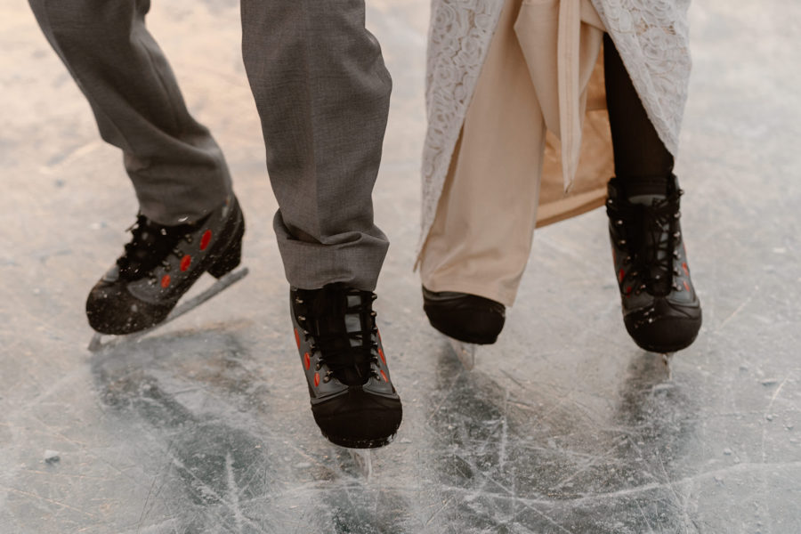 A couple skates on the ice during their ice skating elopement.