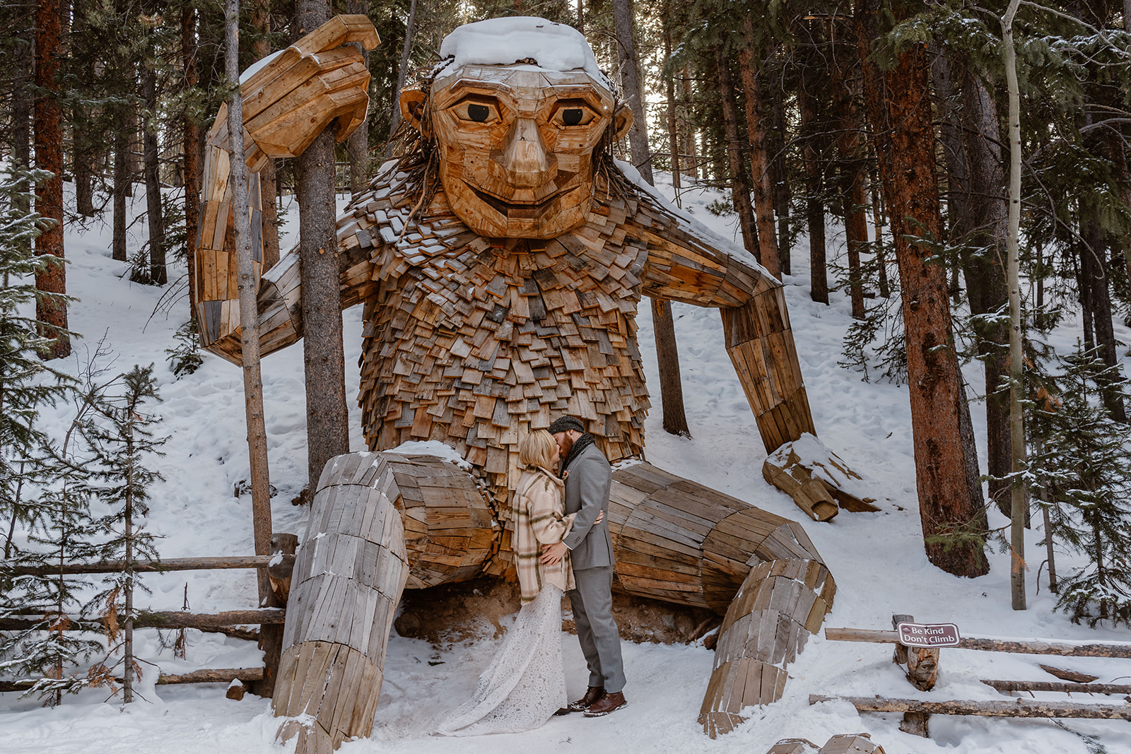 This young couple poses in front of a troll statue in Breckenridge, Colorado, one of the stops they made during their ice skating elopement.