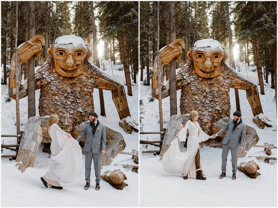 A bride and groom dance in front of a troll statue in Breckenridge, Colorado. 
