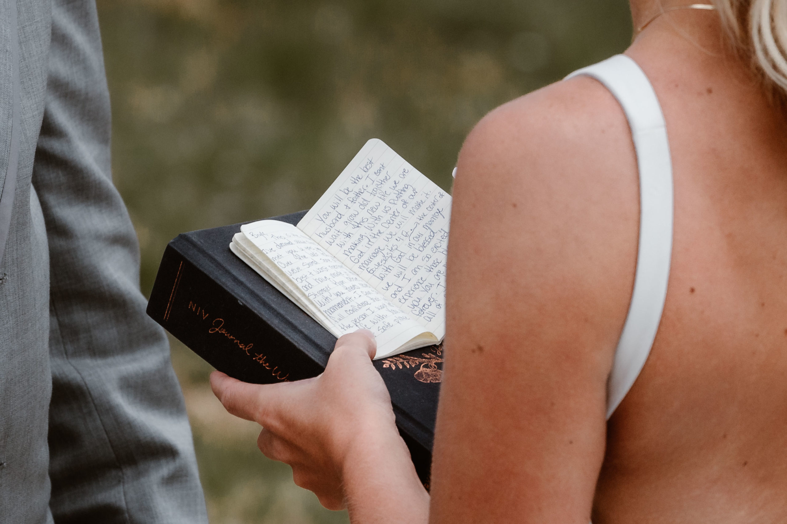 A bride reads her handwritten vows to her husband during their Sapphire Point wedding ceremony.