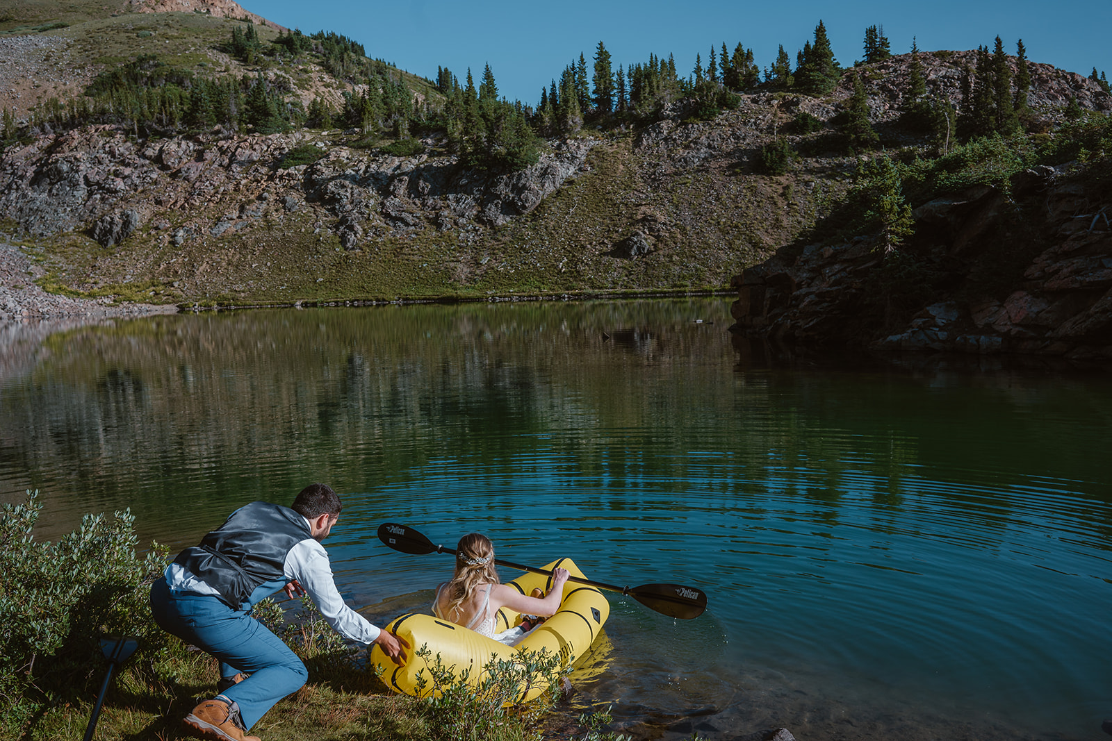 A couple pushes off into a raft during their adventure elopement, a must-consider elopement activity for your elopement day.