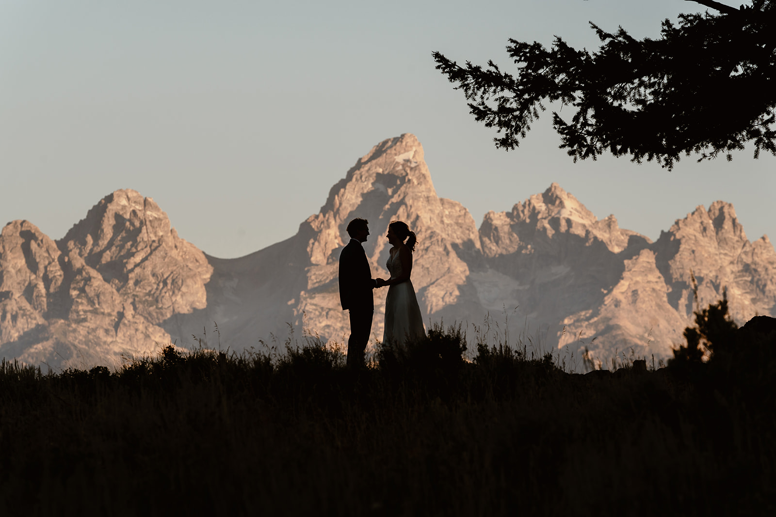 A couple says their vows within the backdrop of The Grand Tetons during their Wyoming elopement. 