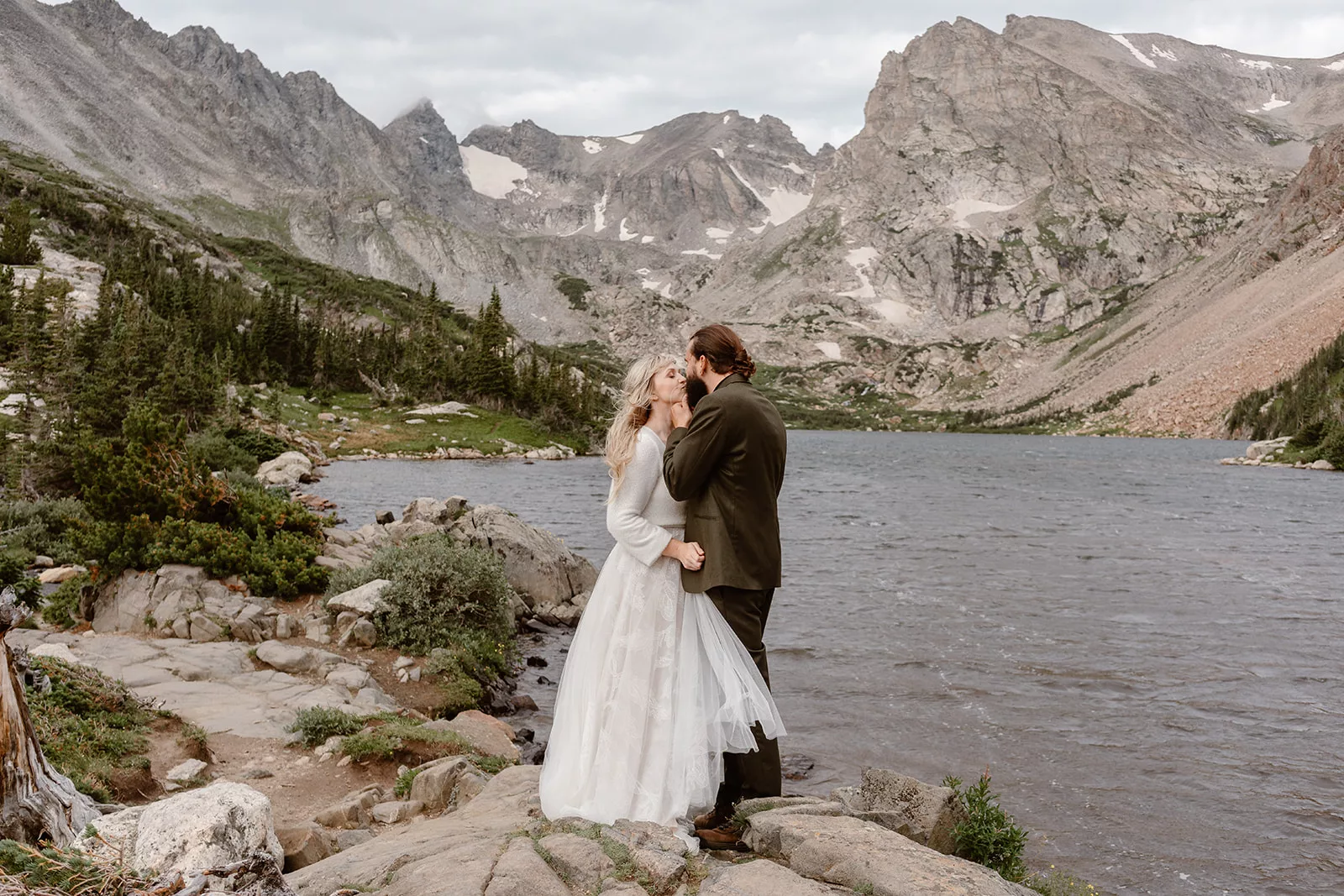 A couple holds each other close during their first kiss, an important part of their elopement ceremony.