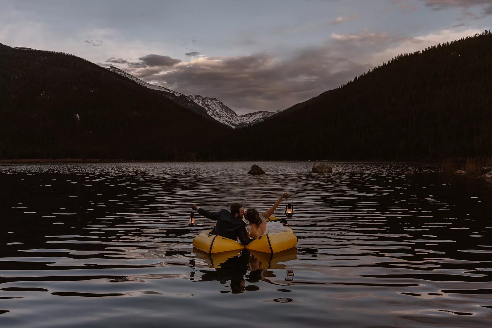 A bride and groom explore and kayak on the lake during their Lake Granby elopement.