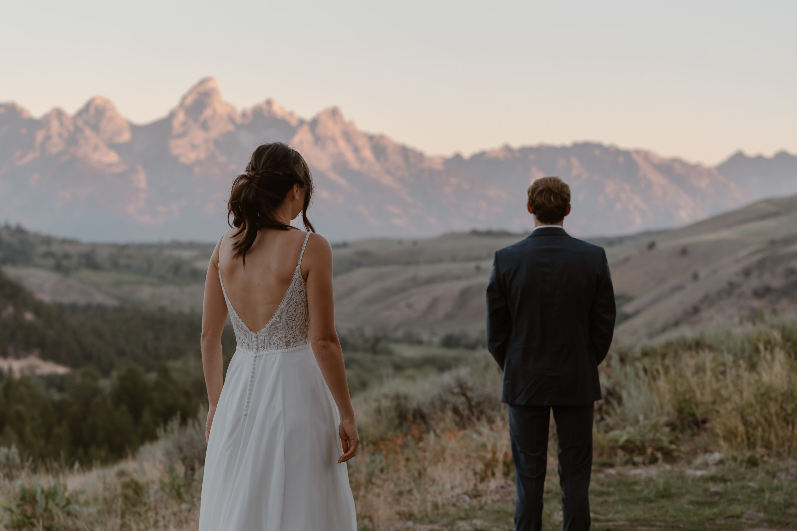 A groom awaits the first look with his soon-to-be wife during their Grand Teton National Park elopement.