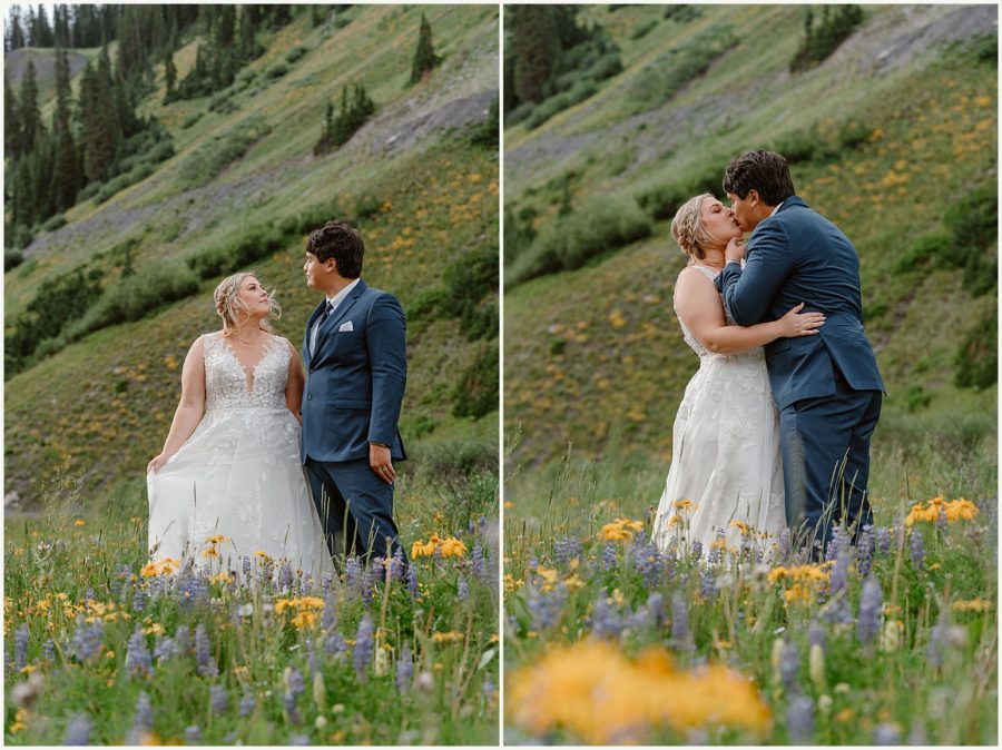 Standing among the wildflowers in Crested Butte, a bride and groom kiss and embrace during their Crested Butte elopement ceremony. 