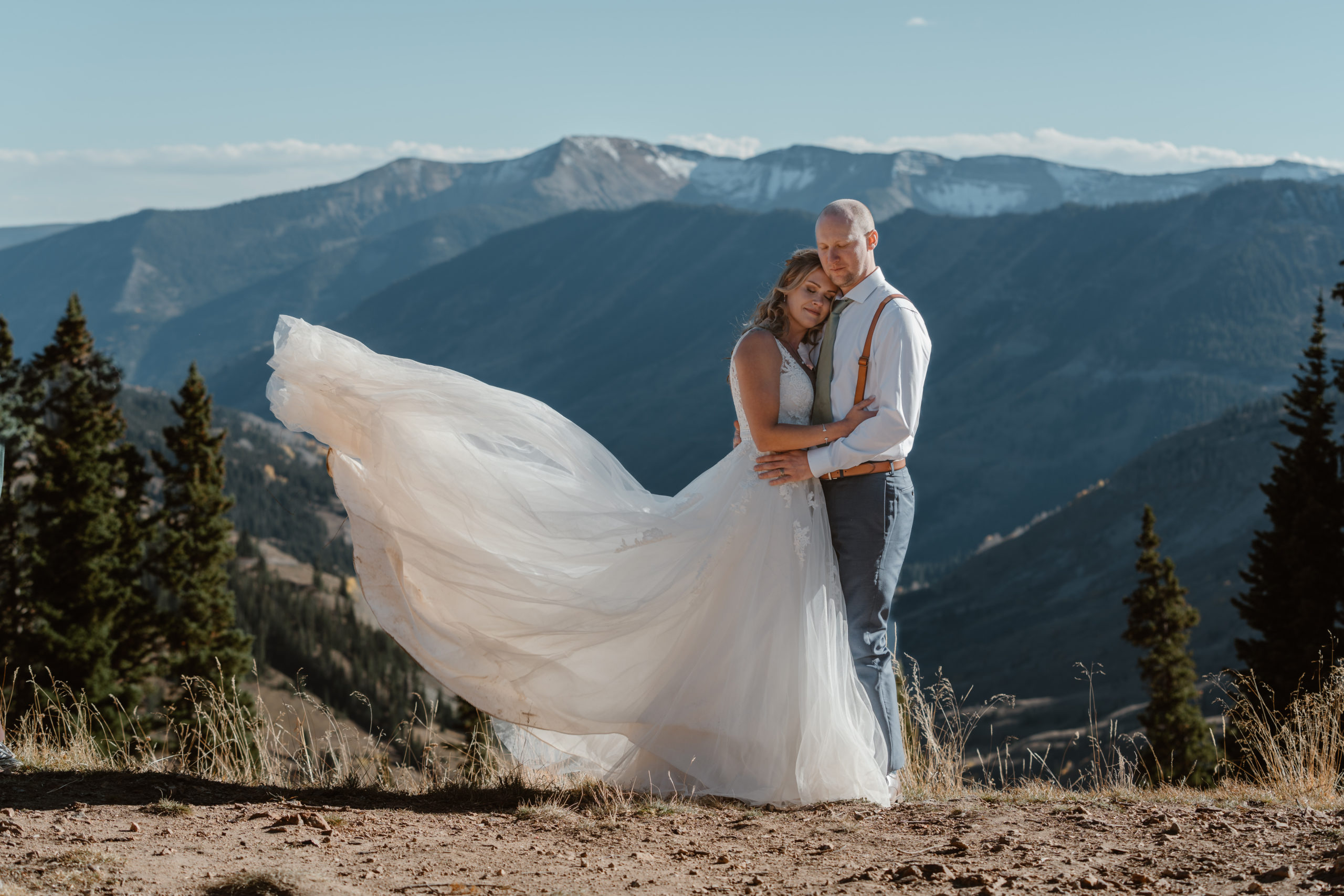 A couple plays around in the mountains during their Fall Crested Butte elopement.
