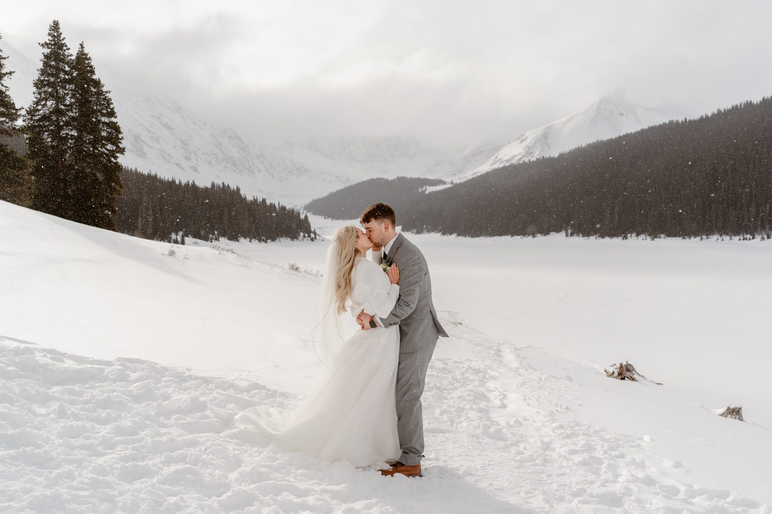 A couple holds each other close during their winter elopement in Breckenridge.