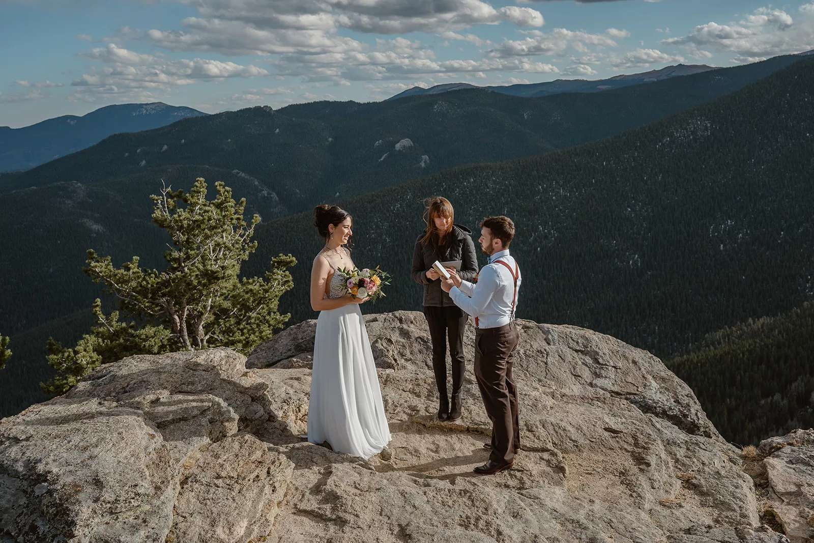 A couple has an officiant guide them through their elopement day ceremony during their adventure wedding.