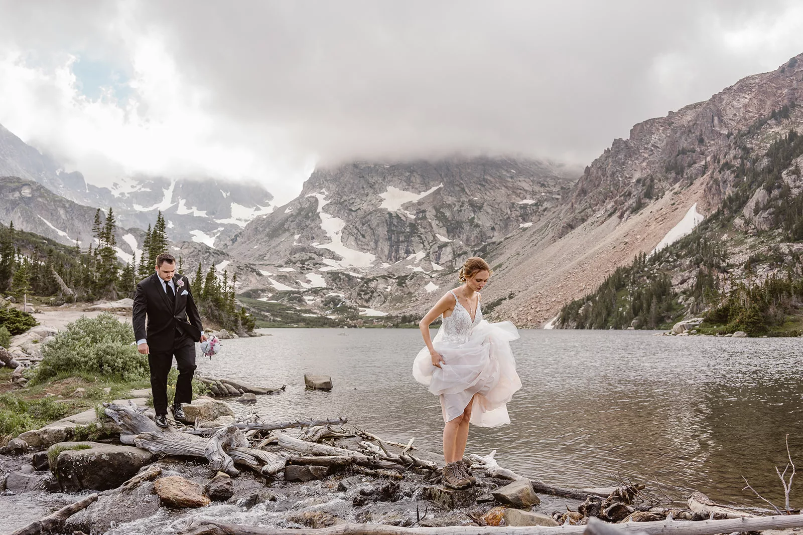 A bride and groom adventure across a lake during their Colorado elopement.