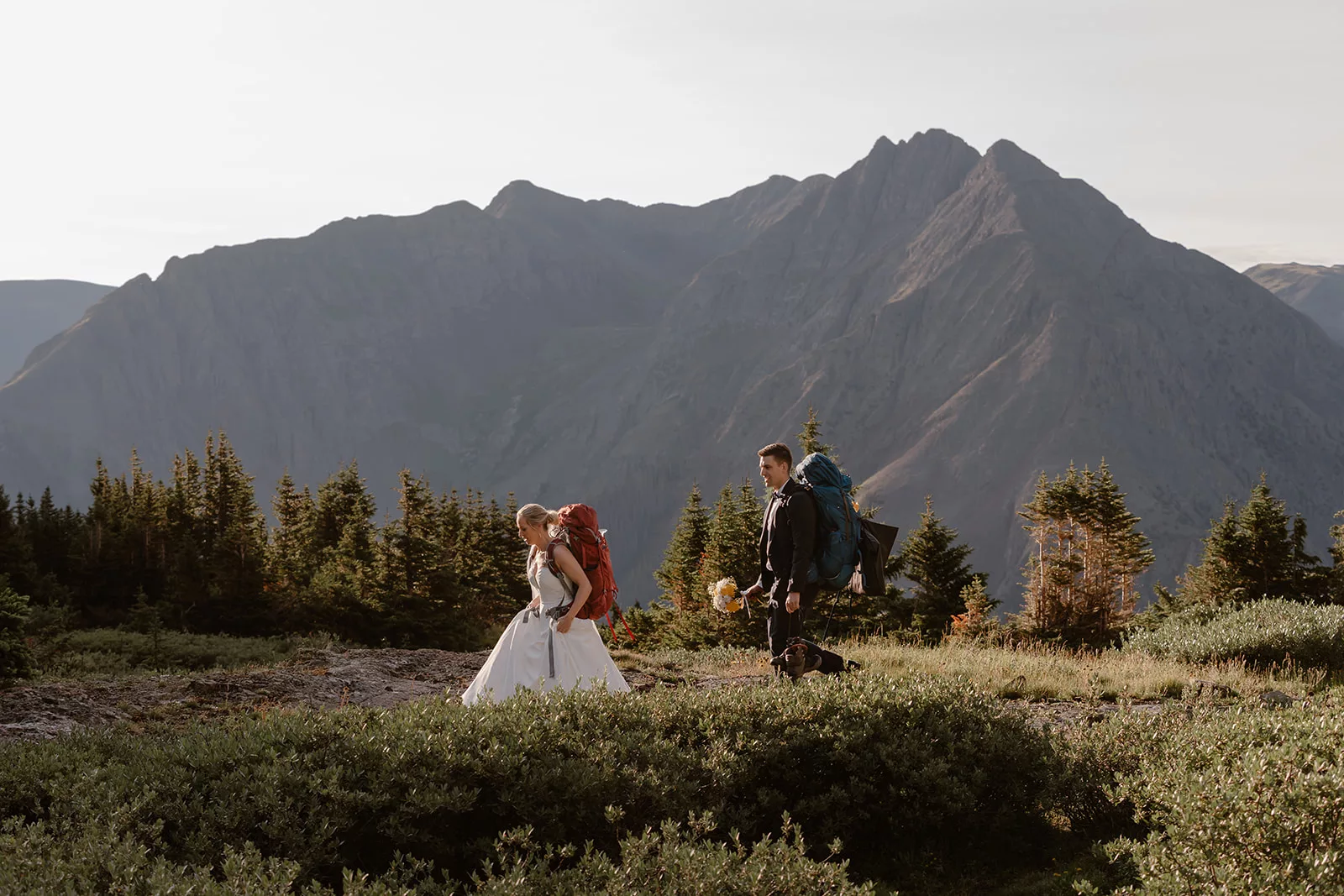 A bride and groom trek to their elopement location as they explore the San Juan mountain range on their elopement day