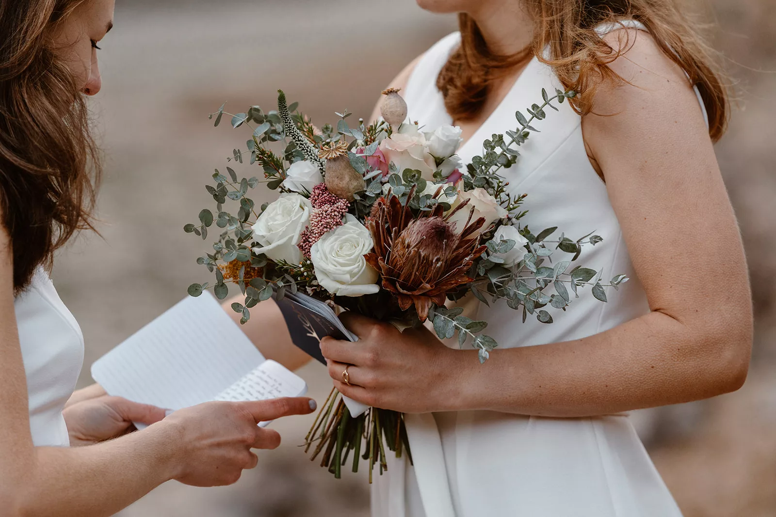 A bride shows off her unique florals on her wedding day during her colorado adventure elopement.