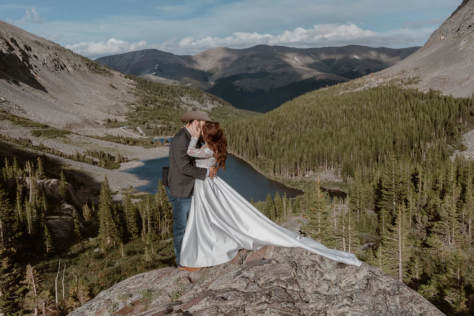 A couple kisses during their elopement ceremony at Blue Lake during their adventure wedding.