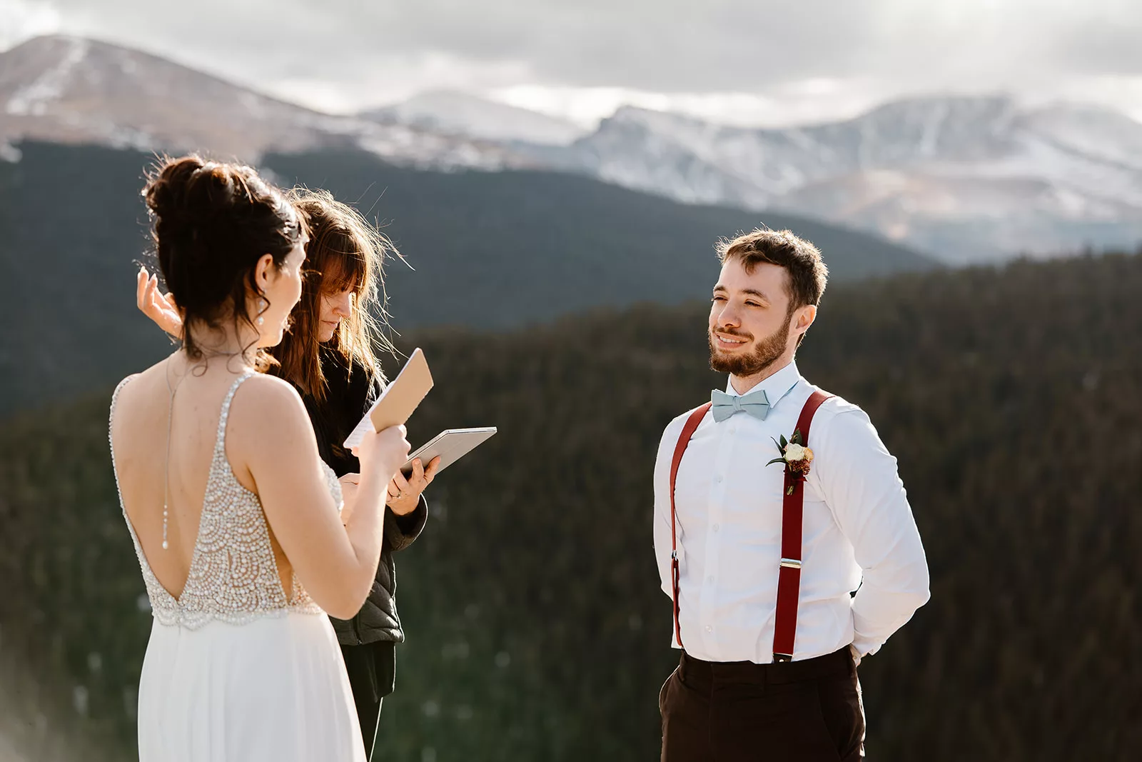 A groom listens to his new bride share her vows during their elopement ceremony.