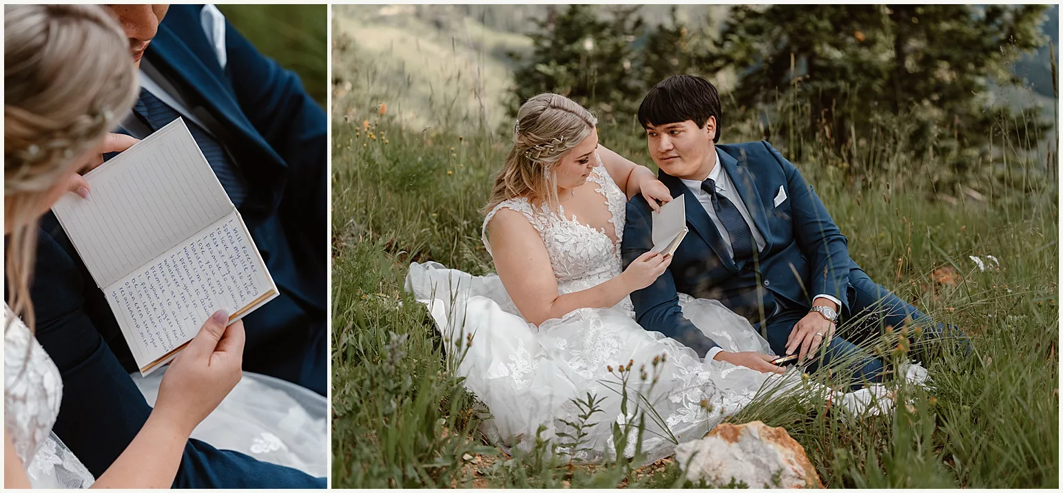 A young couple sits on a mountainside as they enjoy reading their elopement vows to each other.