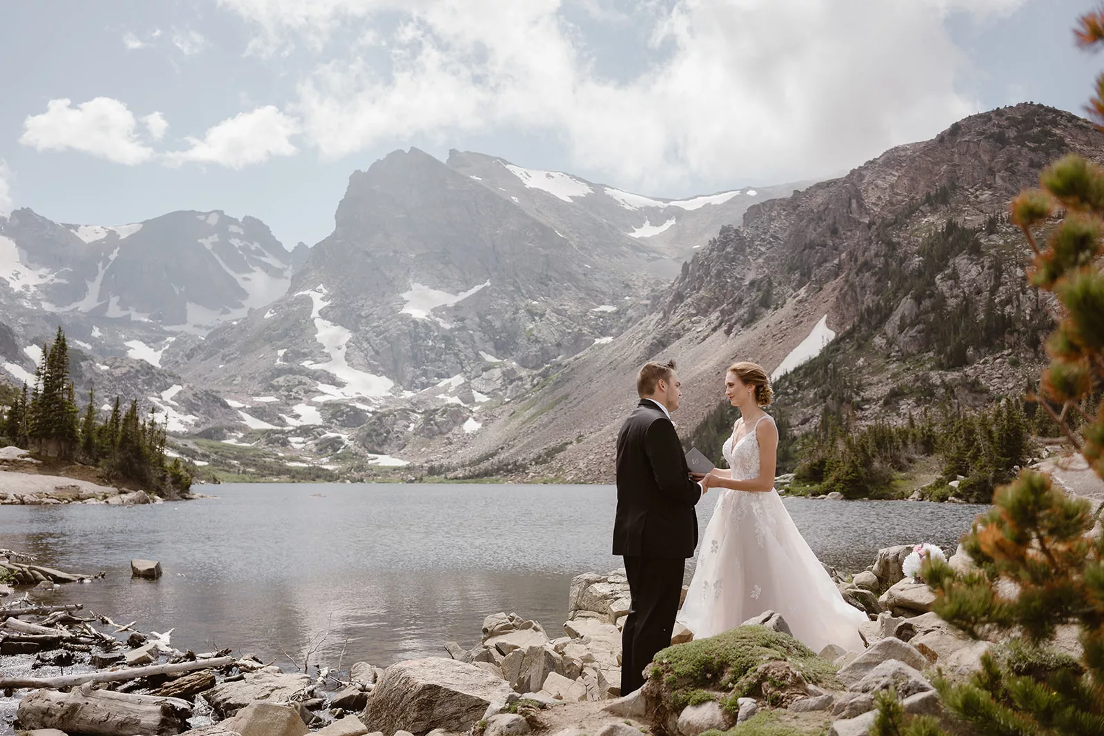 A couple says their vows at Lake Isabelle during their Colorado adventure elopement.