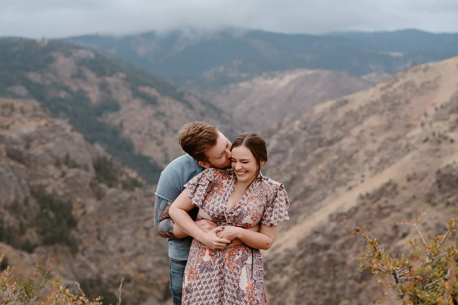 An engaged couple poses for their Denver engagement session on Lookout Mountain near Denver.