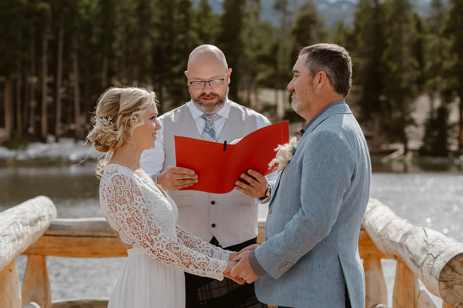 An officiant walks a couple through their elopement day, leading their ceremony.