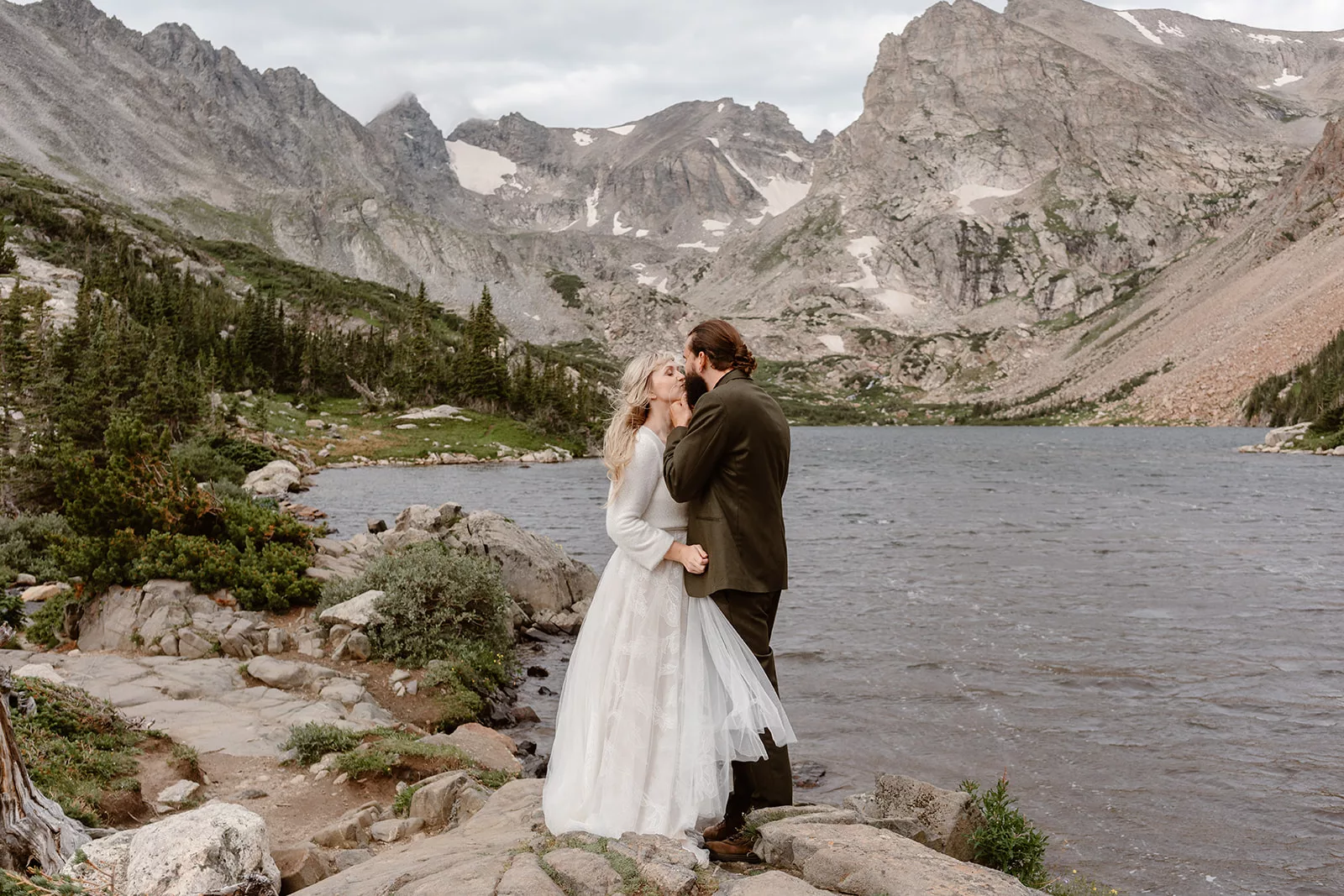 A couple kisses and embraces during their RMNP elopement.