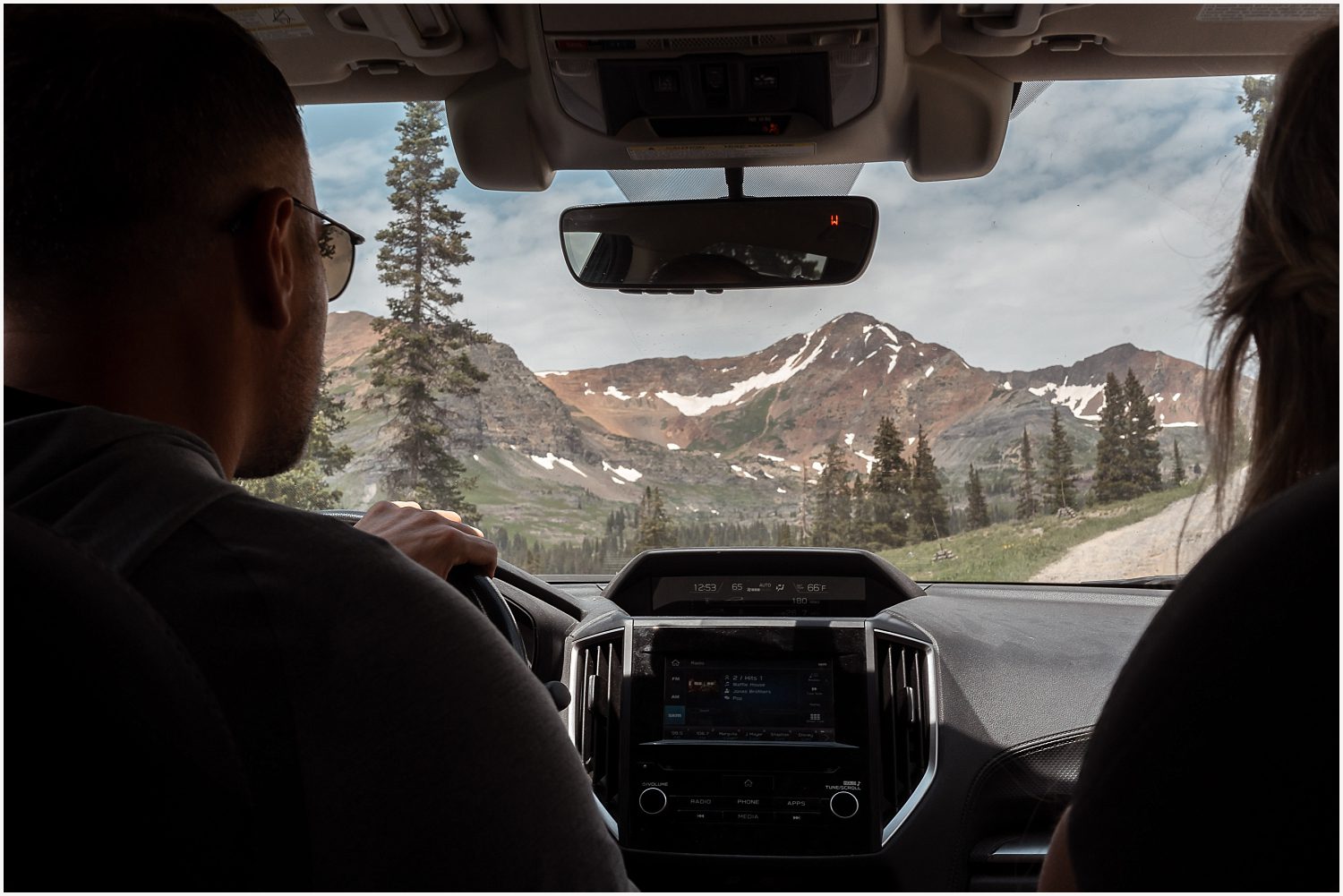 Stunning mountain backdrop as a couple finalizes details for their off-roading elopement adventure.