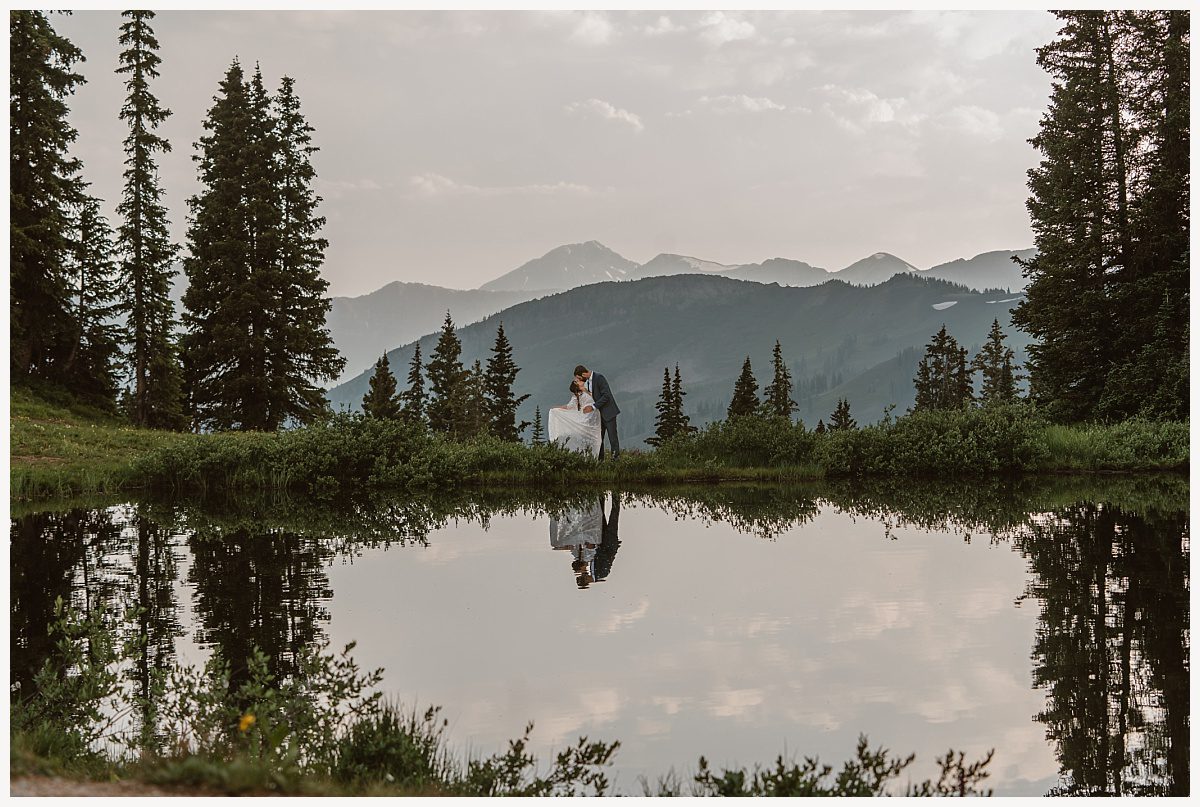 couple eloping by alpine lake, Where to elope, elopement locations, how to pick an elopement location, deciding where to elope, elopement spots, wedding ceremony locations, where to get married outside, married location, where to have elopement location