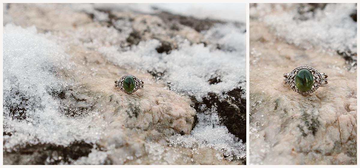 A close-up of a peridot ring during the snowy Breckenridge proposal.